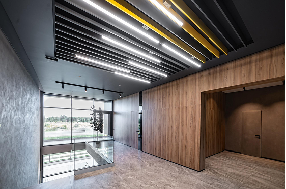 Modern false ceiling with black and yellow panel design and LED strip lighting in contemporary Nungambakkam interior